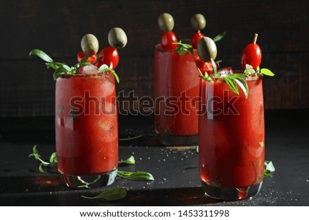 Three glasses with Bloody Mary cocktail