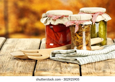 three glasses jars on table napkin of brown color and fork of wood 
