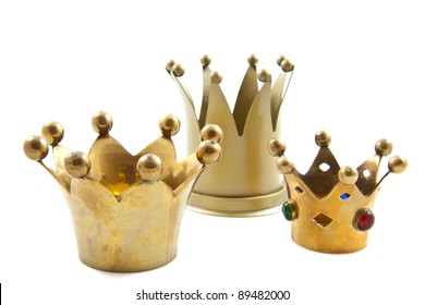 Three Golden Crowns On A White Background