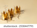 Three Golden crowns with star confetti background for Dia de Reyes Magos day ( Three Wise Men) or Epiphany day, festive greeting card