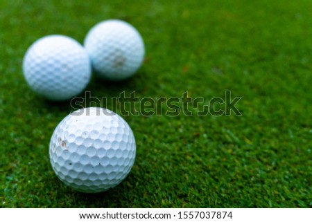 Three golf balls on the green