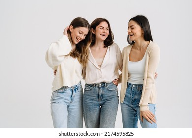 Three gorgeous brunette women posing at camera together isolated over white background