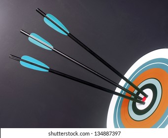 Three Green And Black Archery Arrows Hit Round Multi Colored Target Bullseye Center