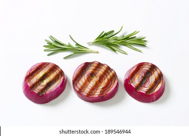 Three Grilled Slices Of Red Onion Accompanied With Sprig Of Thyme