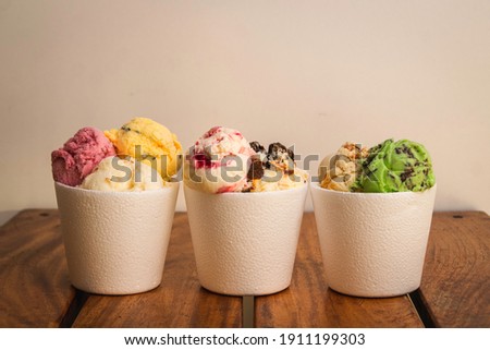 Three half-kilo pots with different ice cream flavors 