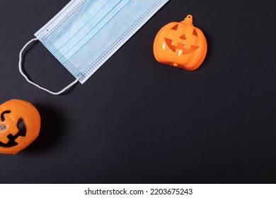 Three halloween pumpkin toys and face mask against grey background. halloween festivity and celebration during covid-19 pandemic concept - Powered by Shutterstock