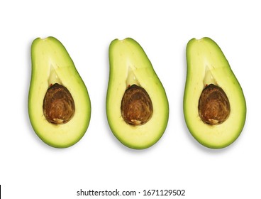 three halves of avocado with bone on a white background