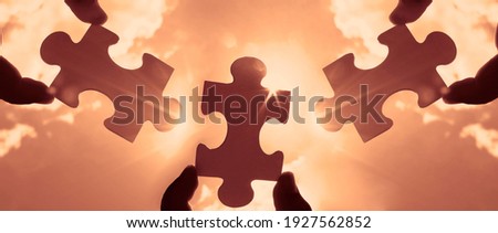 three hands of businessman to connect couple 3 piece with sky background.Jigsaw alone wooden puzzle against sun rays.one part of whole. symbol of association and connection.business strategy.