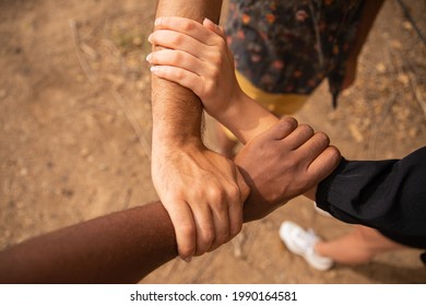 Three Hands Of Different Ethnicities Grasp Each Other And Form A Triangle. Diversity Concept.