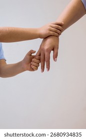 Three hands are touching each other in a triangle shape. Concept of unity and connection between the people