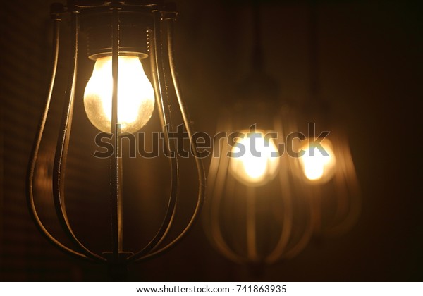 Three Hanging Antique Style Incandescent Lamps Stock Photo