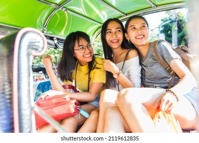 Three Happy Asian Girls Sitting On The Back Of A Tuk-tuk Having Fun And Laughing During The Ride On The Typical Transport In Bangkok - Lifestyle And Friendship