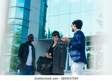 Three Happy Business Colleagues Talking Outside The Office