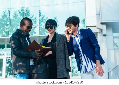 Three Happy Business Colleagues Talking Outside The Office