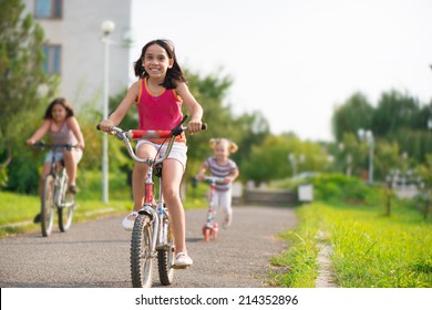 Three happy children riding on bicycle - Powered by Shutterstock