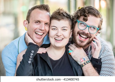 Three happy gender fluid friends mugging for the camera