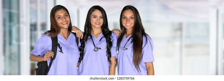 Three happy hispanic nursing students at school