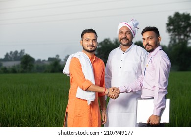 Three Happy Indian Mustache Men Standing Together In Field In Evening Looking On Camera With Laptop, Shaking Hands, Smiling Group Of Males In Crop Land, Greenery, Blurred Background, Skill India.