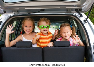 Three Happy Kids In The Car