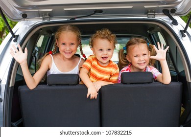 Three Happy Kids In The Car