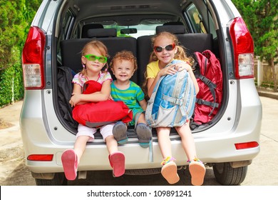 three happy kids in the car