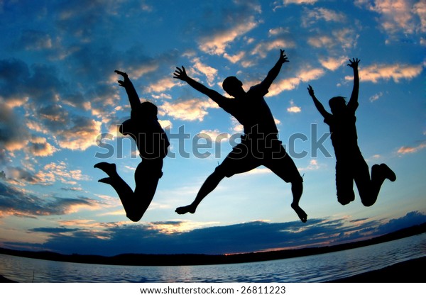 Three happy people\
jumping.