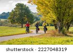 three happy senior adults, riding their mountain bikes in the autumnal atmosphere of the fall forests around city of Stuttgart, Baden Wuerttemberg, Germany