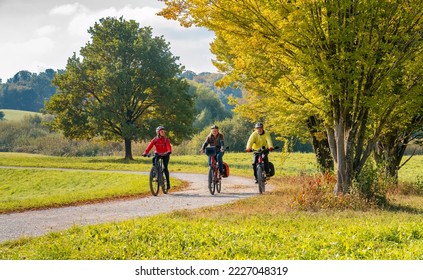 three happy senior adults, riding their mountain bikes in the autumnal atmosphere of the fall forests around city of Stuttgart, Baden Wuerttemberg, Germany - Shutterstock ID 2227048319