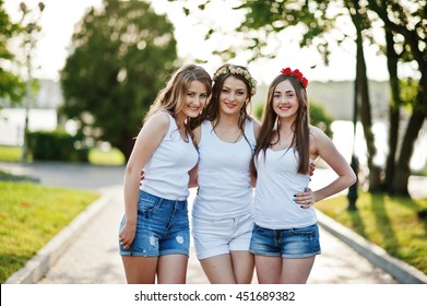 Three Happy And Sexy Girls On Short Shorts And White Shirts Posed On Road At Park On Bachelorette Party