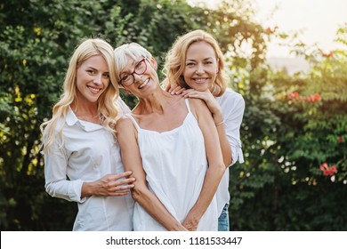 Three happy women smiling, family togetherness 
