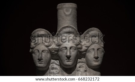 Three headed roman-asian ancient statue of beautiful women at black background, Turkey