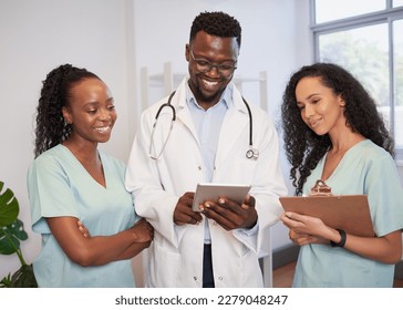 Three healthcare professionals stand in a row discussing patient case with notes - Shutterstock ID 2279048247