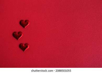 Three hearts, blank Valentine's Day greeting card. Red monochrome romantic background. Banner