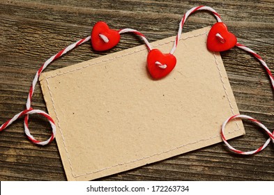 Three hearts and a card on wooden background