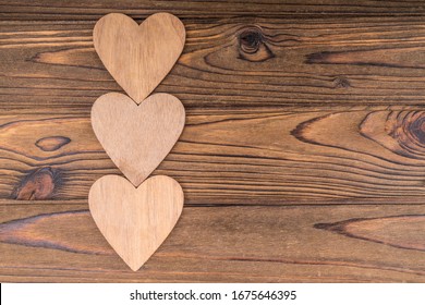 Three hearts, on a wooden background. romantic message, valentine's day. Copy space, lovers day