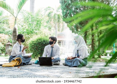 Three High School Children Wearing Masks While Studying Outdoor Group