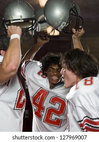 Three High School Football Players.