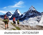 three hikers climbers trekkers mountaineers, way to Mt Everest base camp, Khumbu valley, Sagarmatha national park, Everest area, Nepal Himalayas mountains