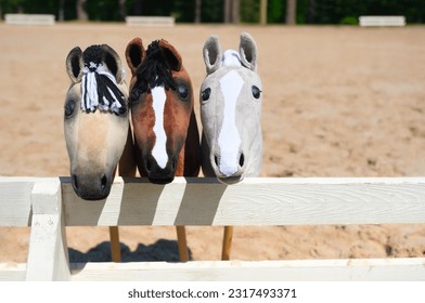 Three hobby horses are waiting for the riders. Equestrian sports. Equestrian equipment. Sports. Summer. The sun. Banner. Outdoors. Close-up - Shutterstock ID 2317493371