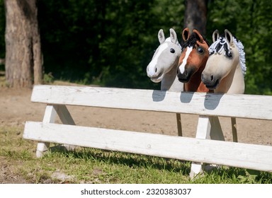 Three hobby horses are waiting for the riders. Equestrian sports. Equestrian equipment. Sports. Summer. The sun. Banner. Outdoors. Close-up - Shutterstock ID 2320383037