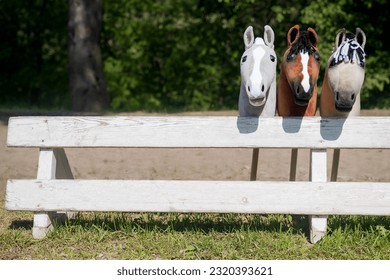 Three hobby horses are waiting for the riders. Equestrian sports. Equestrian equipment. Sports. Summer. The sun. Banner. Outdoors. Close-up - Shutterstock ID 2320393621