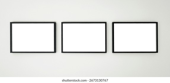 Three horizontal black picture frames hanging on a white wall, clean mockup for artwork, photography, posters, or graphic design presentation in a modern minimalist interior.