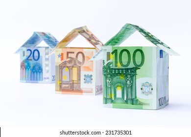 Three houses made of euro notes isolated on white background