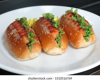 Three Identical Delicious Hot Dogs With Tomato Sauce.