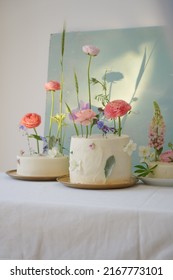 Three Incredible White Wedding Cake With Mixed Fresh Flowers Decorations On The Table In Daylight. Perfect Wedding Dessert Composition