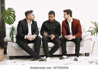 Three Indian Men Discussing Something On Couch