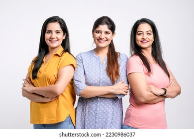 Three indian women giving expression together on white background.