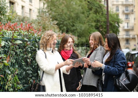 Similar – Image, Stock Photo Twin sisters take pictures of each other with smartphone at a bridge railing