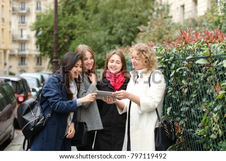 Similar – Image, Stock Photo Twin sisters take pictures of each other with smartphone at a bridge railing