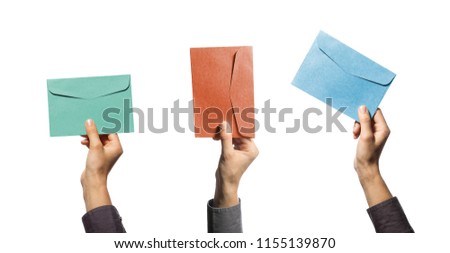 Three isolated hands with colored envelopes on white background.